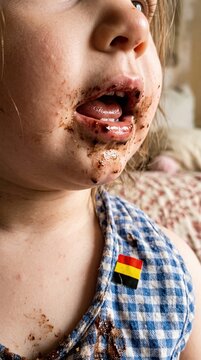 Happy Belgian girl enjoys treat on National Day