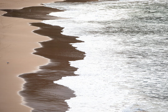 Waves Gently Crashing Sandy Beach Shoreline View