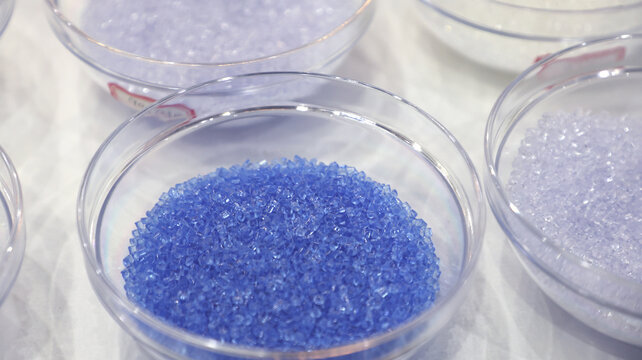Close up of blue transparent polymer resin pellets