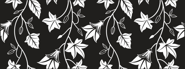 Elegant seamless floral vine pattern with white blossoms and leafy branches on a black background. Decorative repeating botanical design features graceful flowing curves and striking contrast. Perfect © Parul
