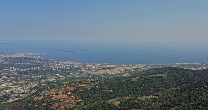 Tanneron France Aerial v22 high angle drone descent shot capturing beautiful coastal seascape of mediterranean sea and overlooking at village settlements and mountain terrain - July 2021