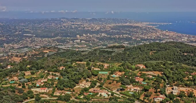 Tanneron France Aerial v25 drone pull out descent shot capturing bay of cannes and reveals hillside homes and agricultural plantations at les plaines - July 2021