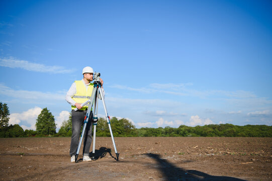 Surveyor geodetic measuring land topography for construction project