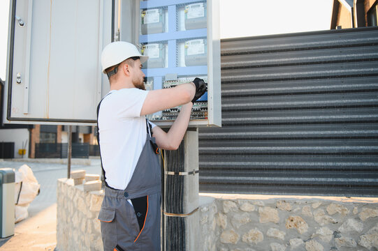 Electrician installing new utility meters and fusebox