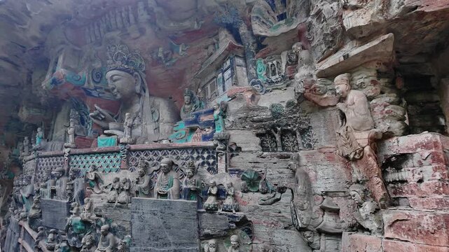 Dazu, China: Panoramic footage of ancient statues in Baodingshan grottoes by walking path in the forest of Dazu rock carvings, famous rock art in Chongqing, China