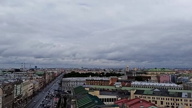 Historic European city rooftops under clouds.