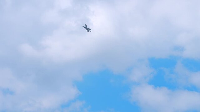 Small airplane flying over blue sky.