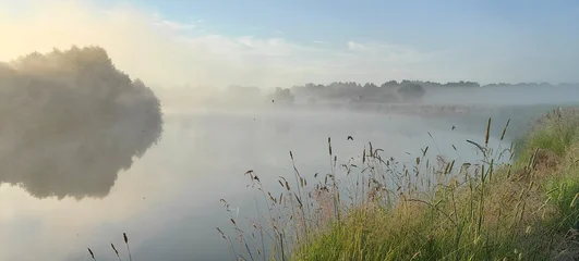 Summer fog over the river—a beautiful, fairytale-like landscape perfect for a desktop background. © Nadzeya Pakhomava