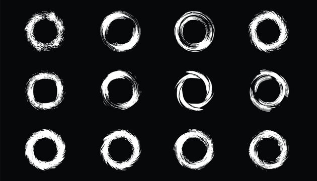 Twelve white chalk or paint brush circles in zen enso style arranged in a grid pattern on a solid black background.