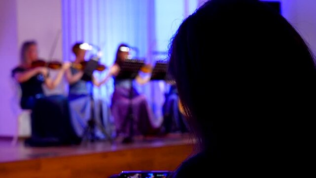 String quartet performing on a blue-lit stage.