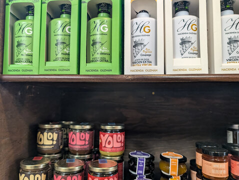 Gaspesie, Quebec, 06 June 2026 : Bottles of Hacienda Guzman organic extra virgin olive oil and Yolo! spreads are displayed on wooden shelves.