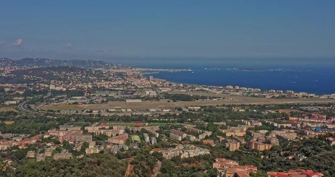 Tanneron France Aerial v32 drone flying toward airport airfield at mandelieu la napoule and its beautiful townscape and bay of cannes with deep blue mediterranean sea - July 2021