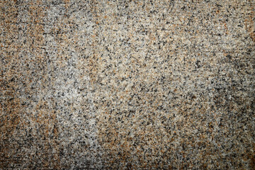 Fototapeta premium Natural stone texture with gray, beige and orange mineral pattern. Fine speckled stone surface..