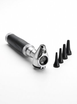 Medical Otoscope Device with Multiple Ear Specula on White Background.
