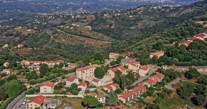Tanneron France Aerial v34 panoramic view pull out shot capturing beautiful mountain terrain landscape and small village rural townscape during daytime - July 2021