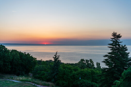 Sunrise over the Sea with Forest Silhouette and Coastal Path
