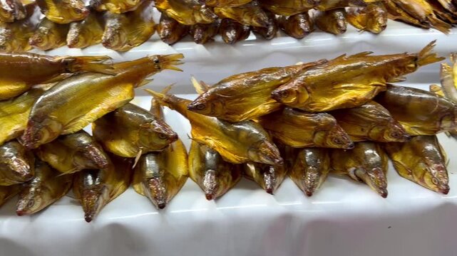 Traditional smoked peled fish displayed on a market counter in Burabay, Kazakhstan. Local food, regional cuisine and tourism gastronomy concept.