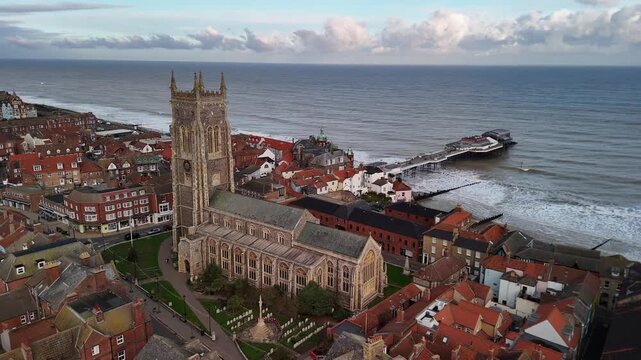 Cinematic Aerial Drone View of Cromer Parish Church and Pier on North Norfolk Coast England UK