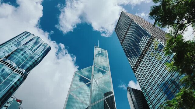 A low-angle shot captures the towering skyscrapers of Hong Kong's central business district