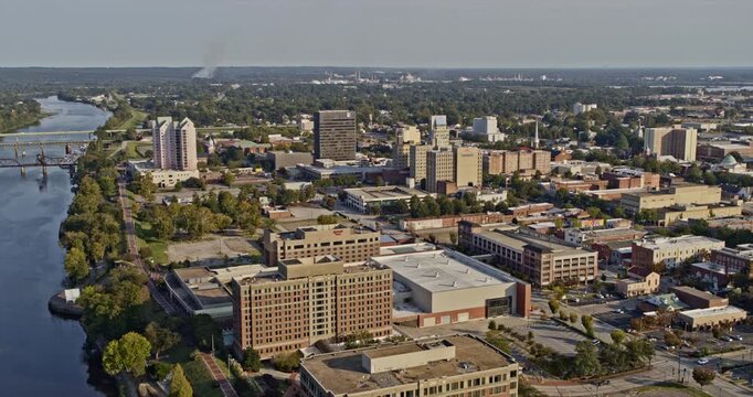 Augusta Georgia Aerial v7 dolly in overlooking at downtown cityscape and distance industrial area with polluted air released into the sky - Shot with Inspire 2, X7 camera - October 2020