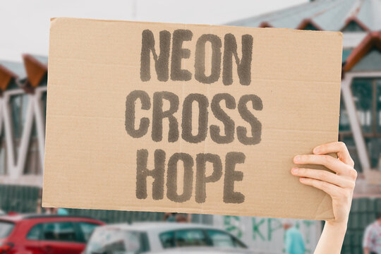 "Neon cross hope" The glowing sign means help is near. MEANS, HELP, NEAR, NEON, HOPE.