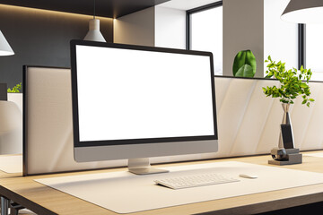 Fototapeta premium Modern office workspace featuring large blank computer monitor on clean desk within contemporary design interior and soft natural lighting background. 3D Rendering