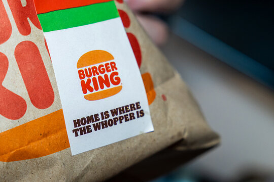 Warsaw, Poland - July 5, 2026: Close-up of a Burger King takeout bag featuring the slogan home is where the Whopper is, highlighting the fast food brand's identity and marketing.