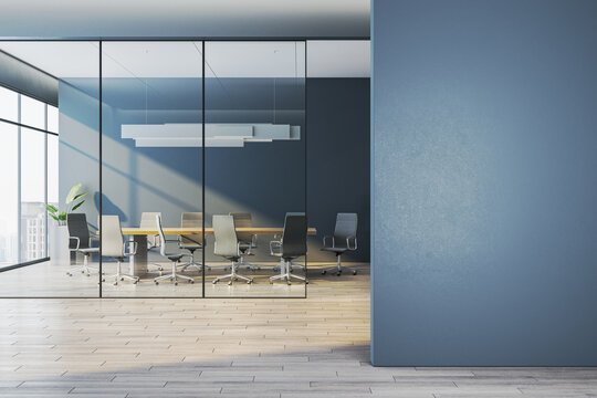 Modern corporate meeting room behind glass walls with empty blue wall foreground as clean mockup space for design templates. 3D Rendering
