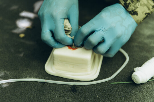 Ukrainian soldier practicing march tactical medical care training