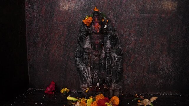 Small black stone idol of Lord Vishnu inside Ratanpur Hanuman Temple, representing divine protection, preservation, and devotion in a sacred Hindu shrine.
