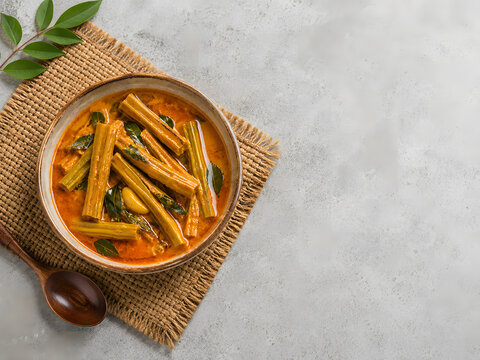 Sri Lankan Drumstick (Murunga) Pod Curry on Woven Mat with Copy Space