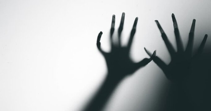 Shadow of a zombie hand on white background
