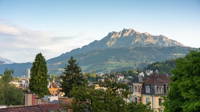 Time lapse of Mount Pilatus with moving shadows and changing afternoon light over the historic rooftops of Lucerne, Switzerland