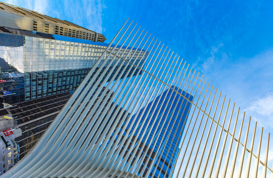 New York City, United States - April 4, 2026: Looking up through the striking white steel ribs of the Oculus transportation hub toward the towering glass facades of skyscrapers in Lower Manhattan.