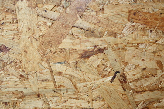 OSB wooden board texture background, oriented strand board close-up