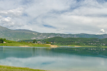 Obraz premium Tranquil Scenery at Rama Lake With Lush Green Mountains and Reflective Blue Water Atmosphere