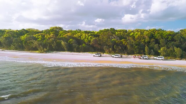 Aerial View of 4WD Vehicles and People at Fraser Island Beach Creek Crossing With Forest