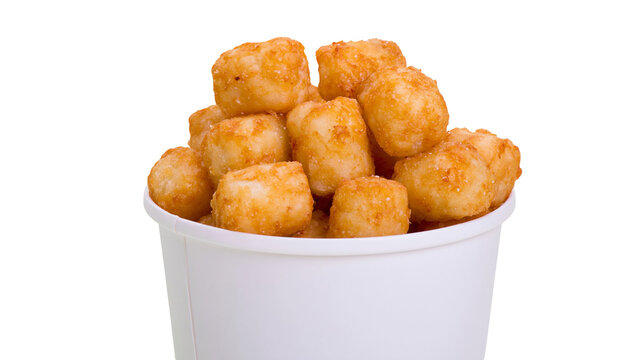 Crispy golden potato tots in white paper cup