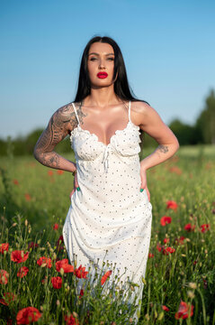 young woman white dress  in poppy field