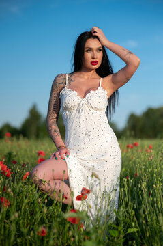 young woman white dress  in poppy field