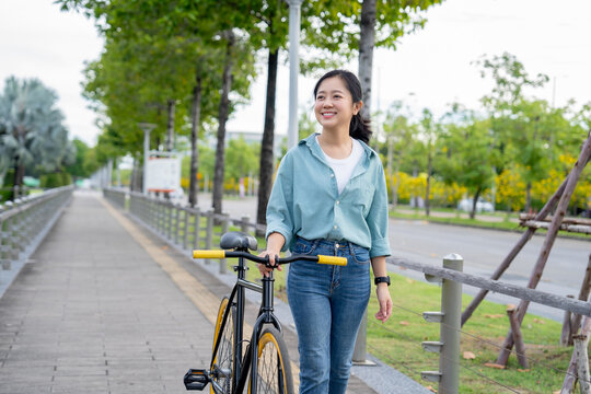 Asian women riding bicycles on the streets. A sustainable, energy-efficient lifestyle.