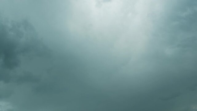 Dramatic 4K timelapse of fast‑moving dark storm clouds rolling across the sky before rain&nbsp;&mdash;&nbsp;ominous atmosphere, evolving cloud formations, and intense weather dynamics for moody backgrounds weather. 