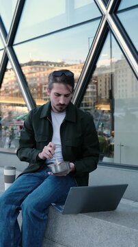 Young entrepreneur having a healthy meal from a reusable container during his lunch break