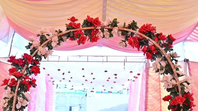 Elegant Floral Wedding Entrance Arch with Red and White Roses Under Decorative Event Canopy. 4k Footage 