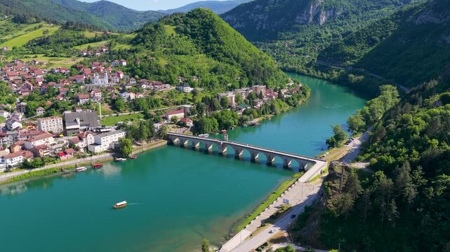 Visegrad, Bosnia and Herzegovina &ndash; May 30, 2026: High aerial view of Mehmed Pasha Sokolovic Bridge connecting both sides of Visegrad above the Drina River