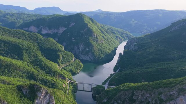 Aerial view of the confluence of the Lim and Drina rivers surrounded by forested mountains and deep valleys