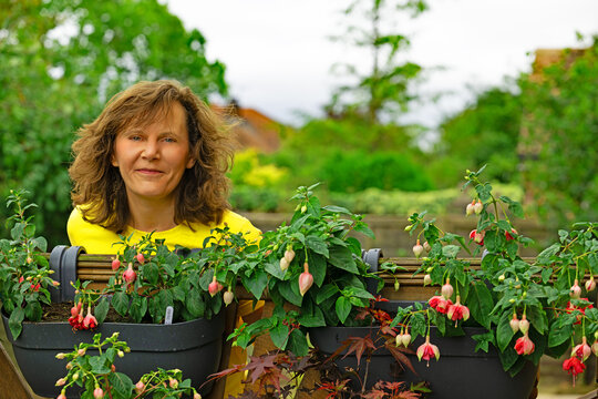 Portrait with first fuchsia flowers forming.