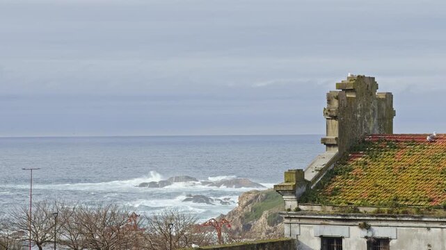 Ocean waves beside coastal building
