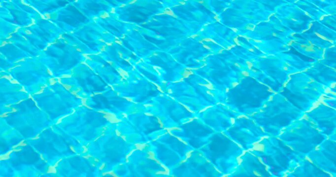 clear blue swimming pool water with shimmering reflections and tiled pattern, gentle moving ripples, abstract summer background ideal for travel, leisure, relaxation, wellness, refreshing, luxury pool