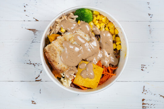 Warm spicy numbing basa fish rice bowl topped with creamy pepper sauce
